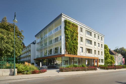 a building with an ivy covered facade on a street at At the Park Hotel in Baden