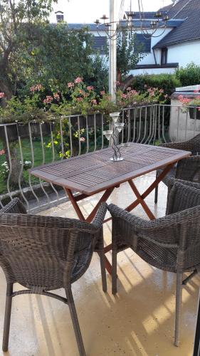 a wooden table and two chairs and a table and chairs at Ferienwohnung am Theo Carlen Platz in Ormesheim