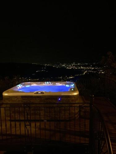 a blue tub sitting on top of a building at night at Villa Ghiandai in Arezzo