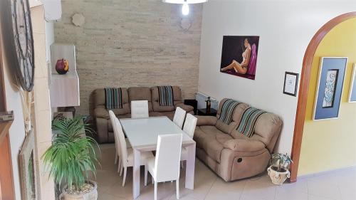 a living room with a couch and a table at B&B Gi & Giò in Càbras