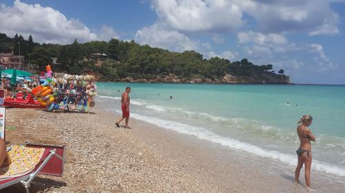 a group of people standing on a beach at Villetta Delizia in Scopello