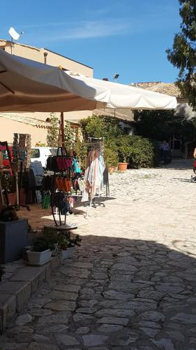 a large white umbrella sitting on a patio at Villetta Delizia in Scopello