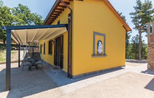 a yellow house with a blue roof at Villa Ghiandai in Arezzo