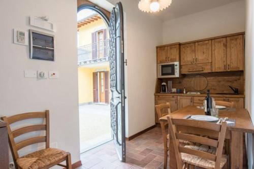 a kitchen with a wooden table and a dining room at Villa Ghiandai in Arezzo