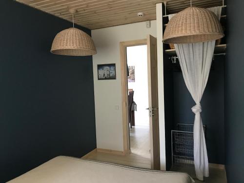 two lamps hanging above a bed in a room at Apartment near by sea in Jūrmala