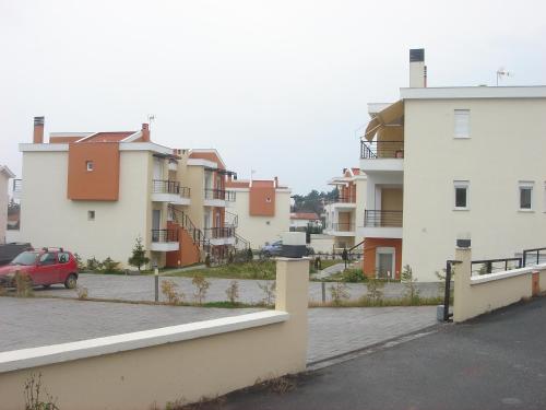 a row of apartment buildings in a parking lot at Sol y Mar in Órmos