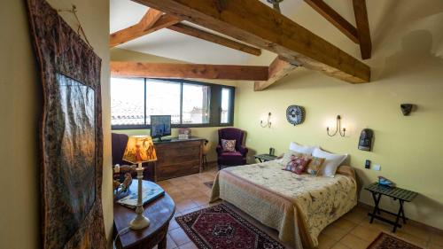 - une chambre avec un lit et un bureau dans l'établissement L'Ancienne Auberge, à Puycelci