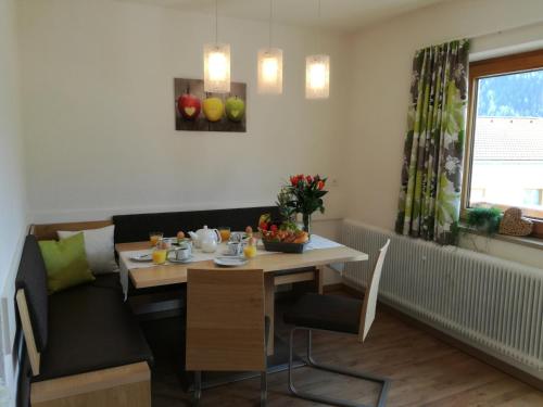 a dining room with a table and a couch at Apart Diamant in Nauders