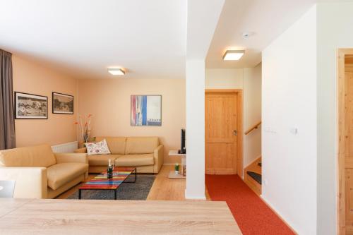 a living room with a couch and a table at Chalet6harrachov se saunou in Harrachov