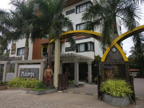a statue of a man in front of a building at Hotel Hampi International in Hospet