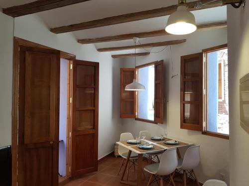 a dining room with a table and chairs and windows at FLORIT FLATS - The Mercado Central Apartment in Valencia
