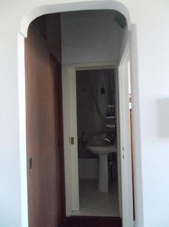 a hallway to a bathroom with a sink and a mirror at Casa Montagnese in Anacapri