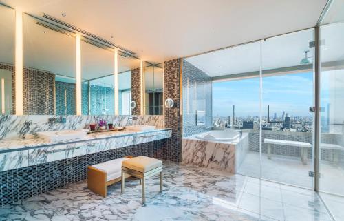 a bathroom with two sinks and a tub and a window at The Prince Gallery Tokyo Kioicho, a Luxury Collection Hotel in Tokyo