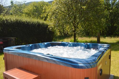 a large hot tub with water in a yard at The Ranch Lodge in Benmore