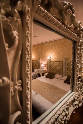 Ένα ή περισσότερα κρεβάτια σε δωμάτιο στο Hostal Goya Suites