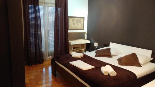 a bedroom with a large bed with towels on it at Apartment Adriana in Trogir