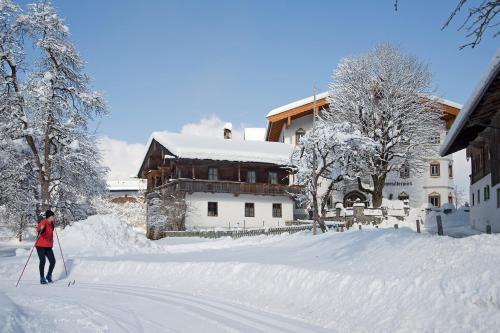 a woman is cross country skiing in the snow at Der Schwendterwirt in Schwendt