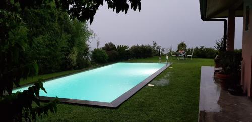 a swimming pool in the yard of a house at B&B Renalù in Verbania