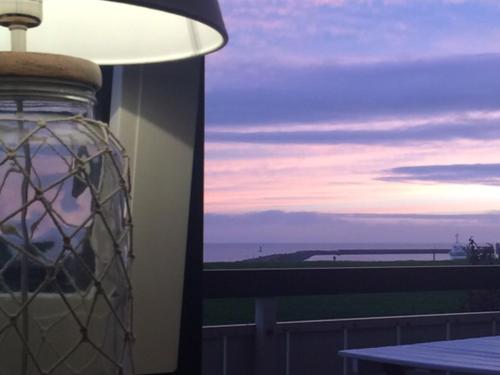 a lamp with a view of the ocean from a balcony at Hus Kiek in de See in Cuxhaven
