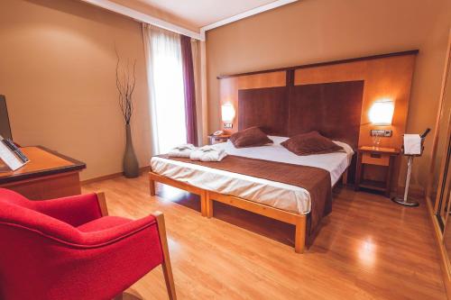 En eller flere senge i et værelse på Hotel Bardo Recoletos Coco