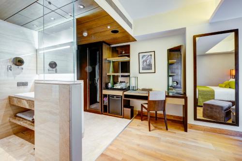 a bathroom with a shower and a bedroom at THE WAY Dhaka in Dhaka