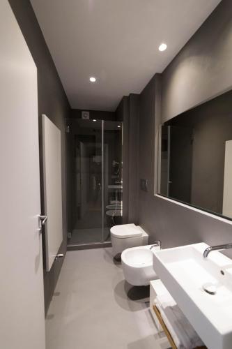 a bathroom with a toilet and a sink and a mirror at Al Pescatore - B&B in Bari