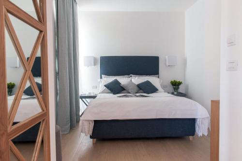 a bedroom with a large bed with a blue headboard at Al Pescatore - B&B in Bari