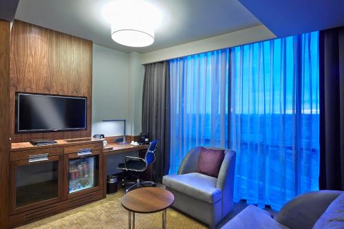 a hotel room with a chair and a desk and a television at Uranus Istanbul Topkapi in Istanbul