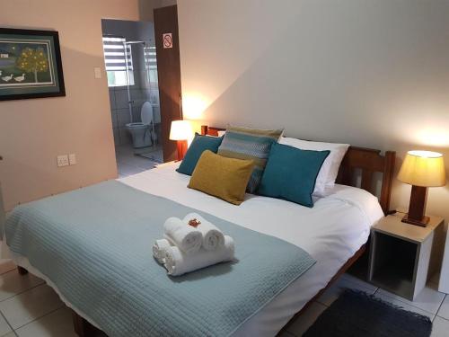 a bedroom with a bed with two towels on it at JS Inn in Nelspruit