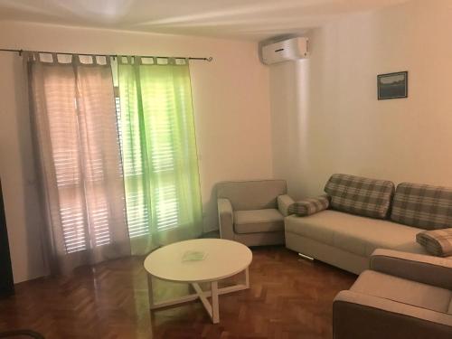 a living room with a couch and a table at Lux dodo in Dramalj