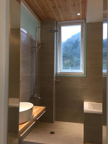 a bathroom with a tub and a sink and a window at Xianel Vacation Chateau in Dahu