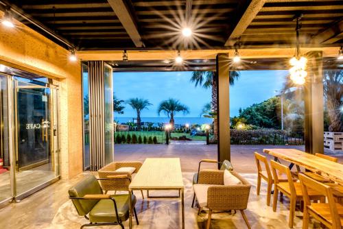 a patio with a table and chairs and a view of the ocean at Jeju Aurum in Seogwipo