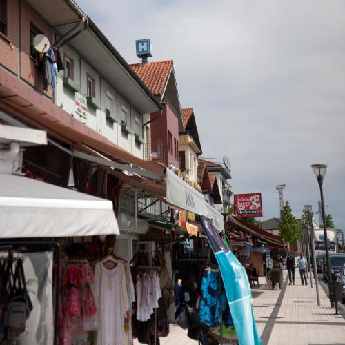 a street with a market with clothes and shops at Hotel Aitana in Irún