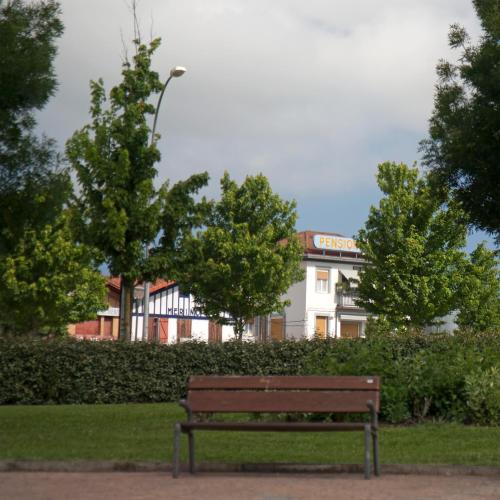 a park bench sitting in front of a building at Hotel Aitana in Irún