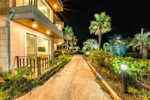 a dirt road in front of a house at night at Jeju Aurum in Seogwipo