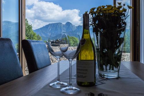 a bottle of wine and two glasses on a table at Giewont Residence in Kościelisko