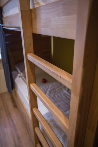 a cupboard with wooden shelves in a room at Safestay Warsaw Old Town in Warsaw