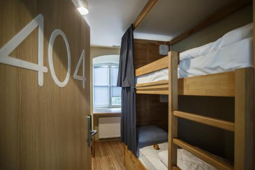 a small room with two bunk beds and a window at Safestay Warsaw Old Town in Warsaw