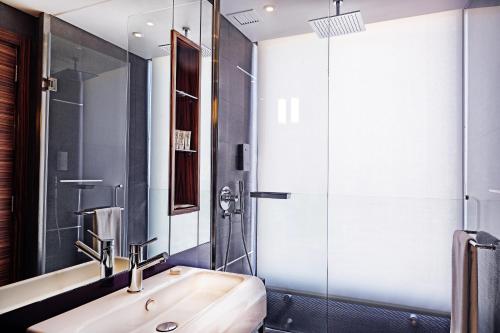 a bathroom with a sink and a shower at Warwick Stone 55 Hotel Beirut in Beirut
