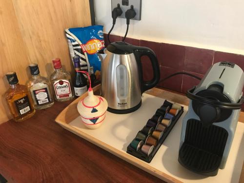 a coffeemaker sitting on top of a counter with a coffee maker at Pili Pili Boutique Hotel in Kigali