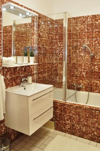 a bathroom with a sink and a shower at Atmospheric Quiet Apartment in Prague