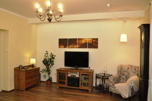 a living room with a flat screen tv on a stand at Atmospheric Quiet Apartment in Prague