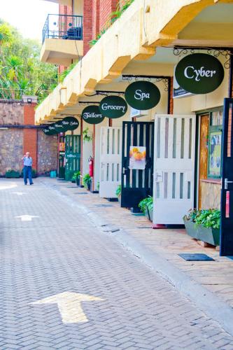 a street lined with stores with signs on them at Njema Court Apartment in Nairobi