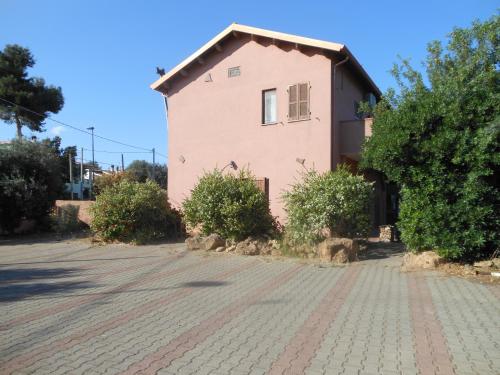 a house on the side of a brick road at La Tavernetta in Masainas