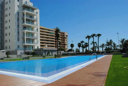 a large swimming pool in front of a building at Aqua Nature 27D in La Mata