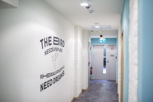 a hallway in a hospital with a sign on the wall at Safestay Warsaw Old Town in Warsaw