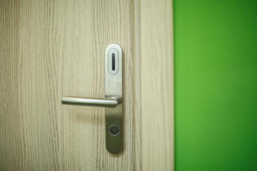a close up of a wooden door with a handle at Safestay Warsaw Old Town in Warsaw