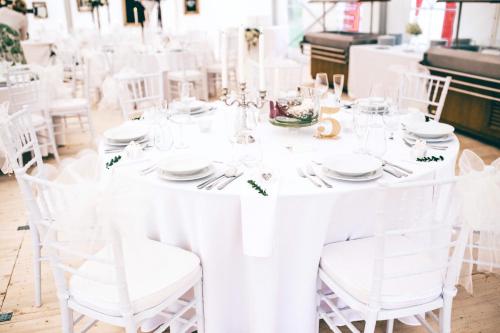a white table set up for a wedding at Hotel Panství Dlouhá Lhota in Dlouhá Lhota