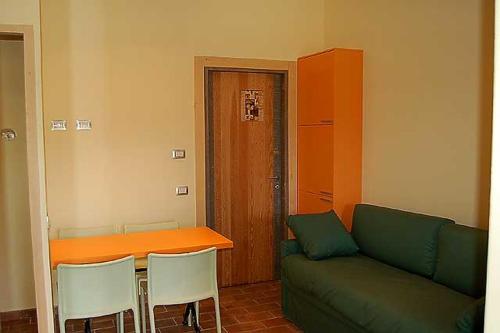 a living room with a green couch and a table at Casavacanze Sant'Eugenia in Attigliano