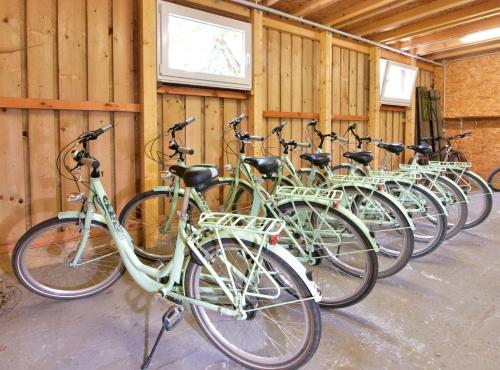 a row of green bikes parked in a building at Waldhotel Eiche in Burg